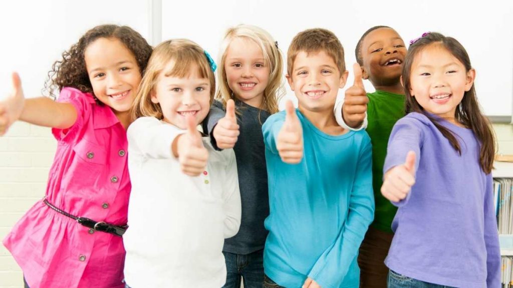 6 kids excited to be in school thumbs up