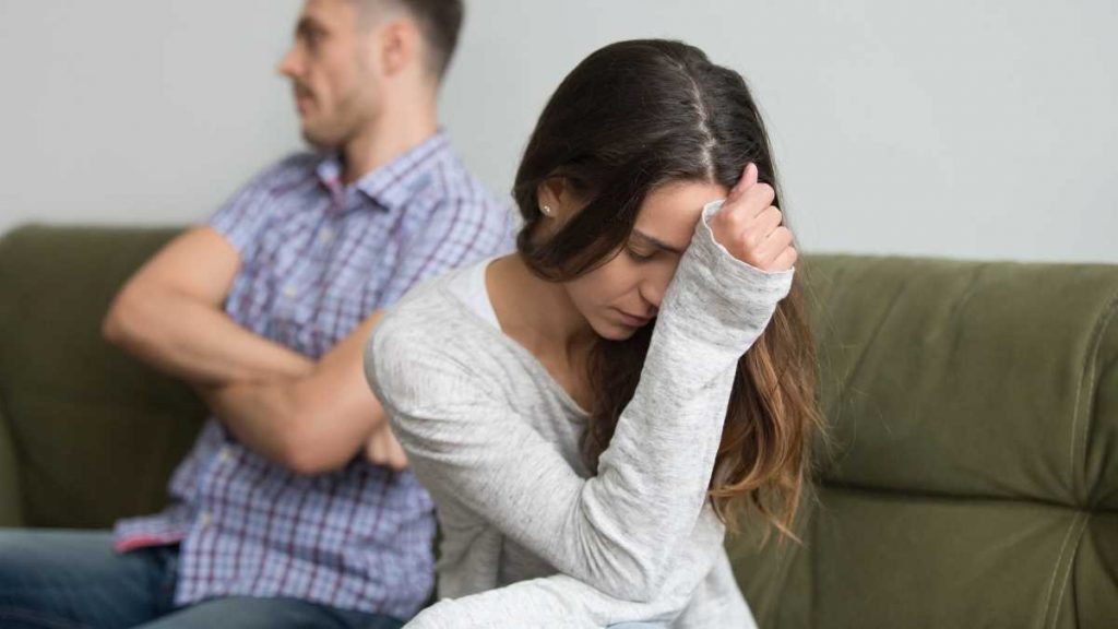 annoyed mom and dad on couch, strong willed stubborn husband