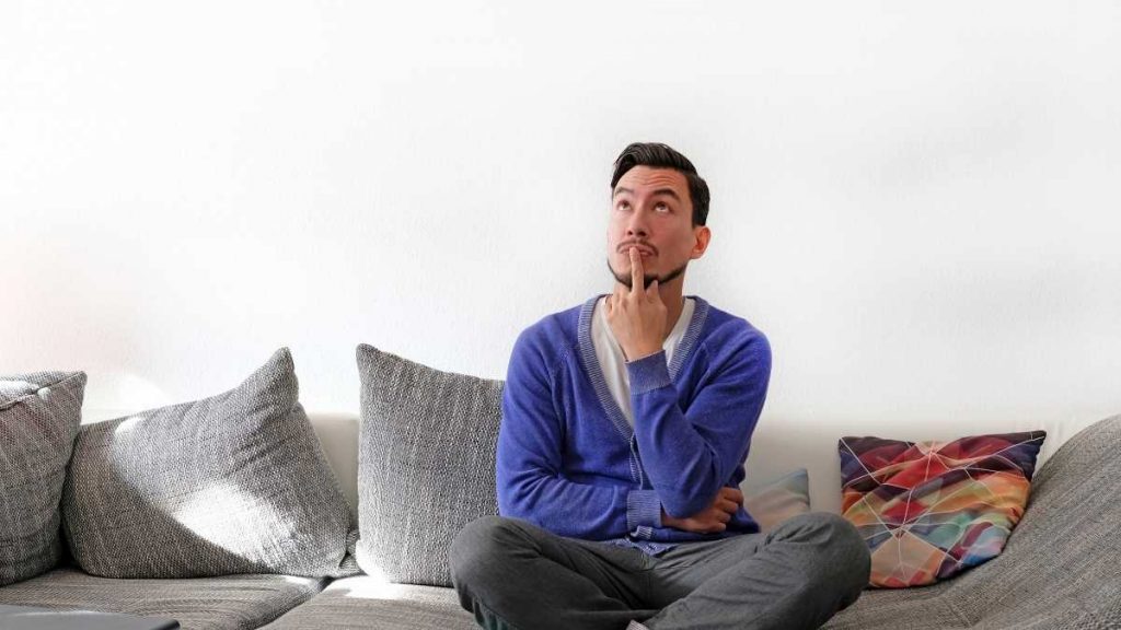 husband on couch considering options