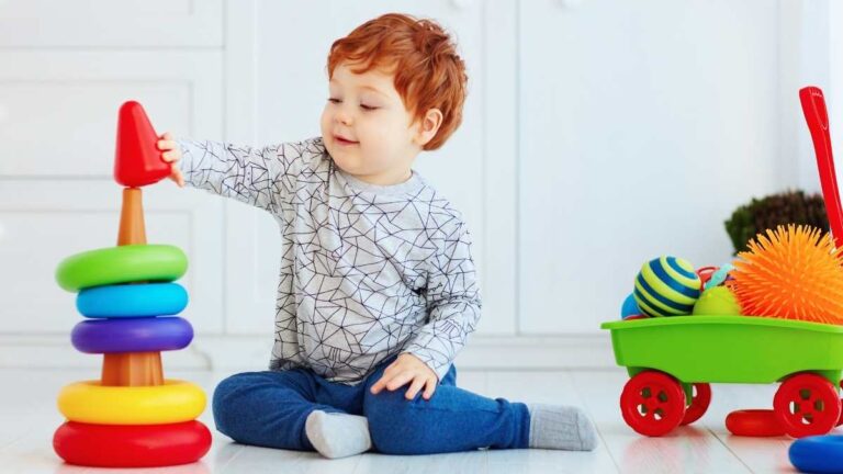 toddler playing cause and effect toys