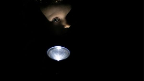 toddler playing with flashlight