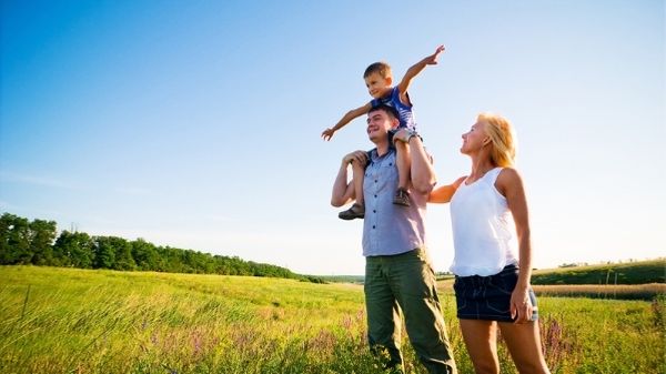 parents and son in a field