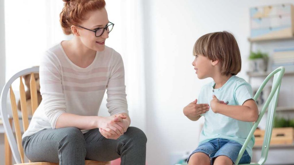 mom listening to child on chairs