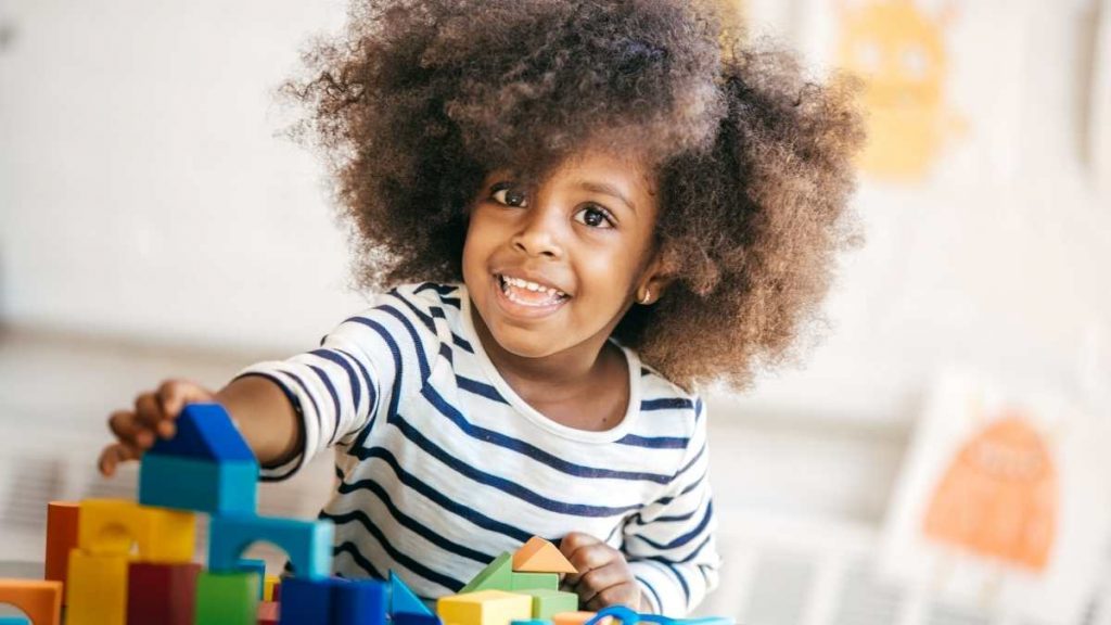 toddler developing core skills using building blocks