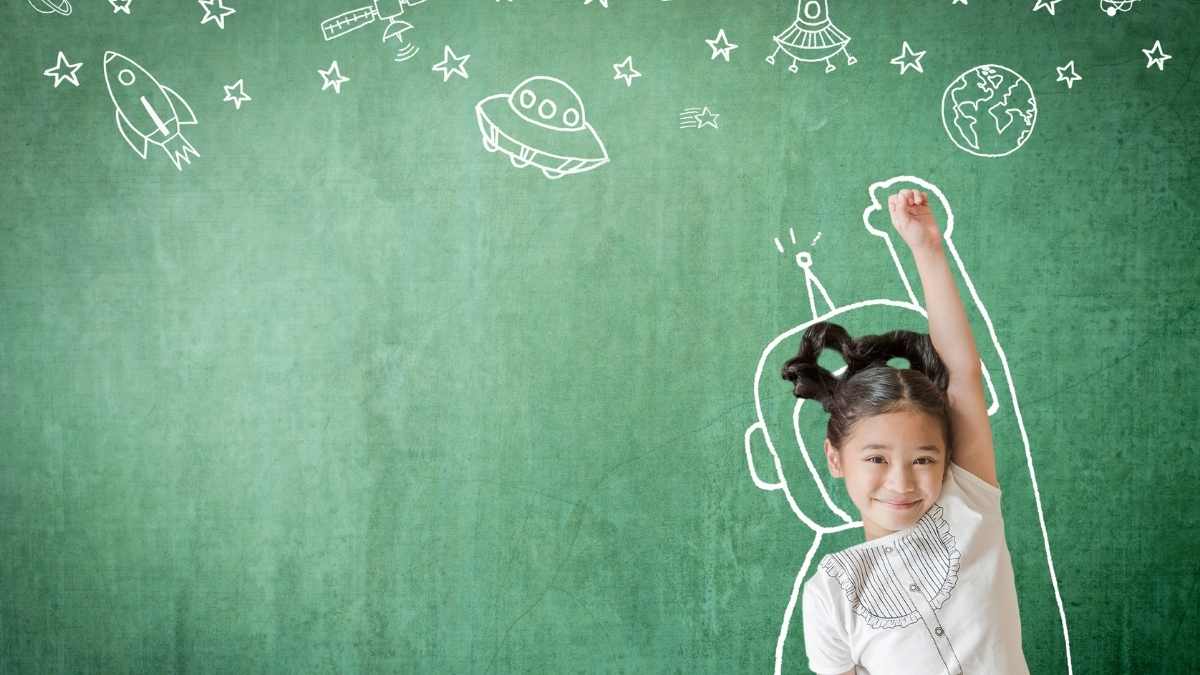 girl in front of blackboard at school with fist in the air