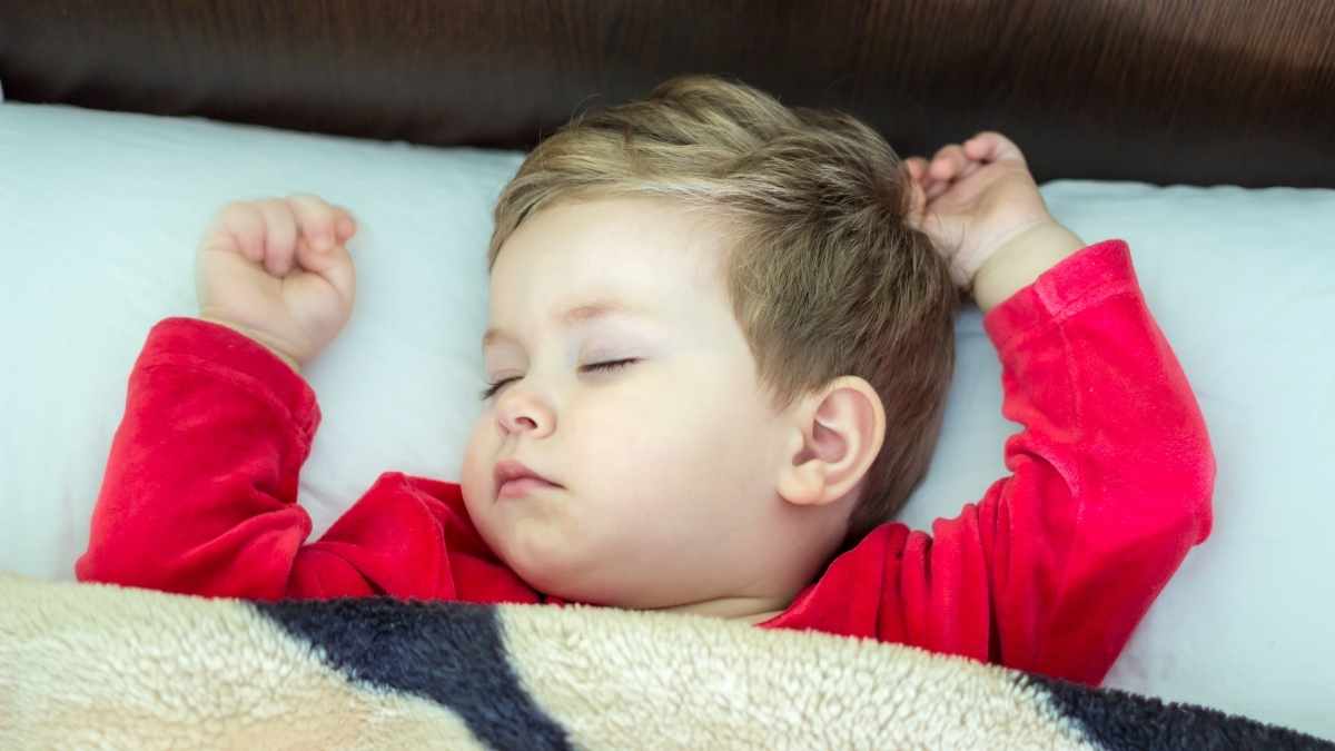 toddler sleeping with arms in the air