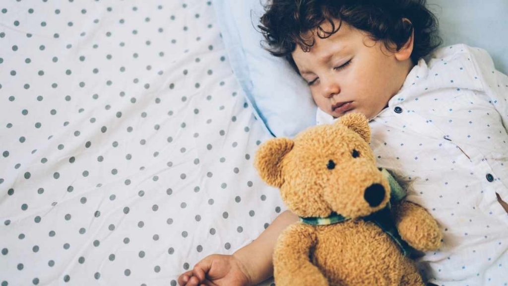 toddler sleeping with teddy