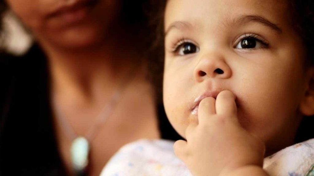 child eating fingers