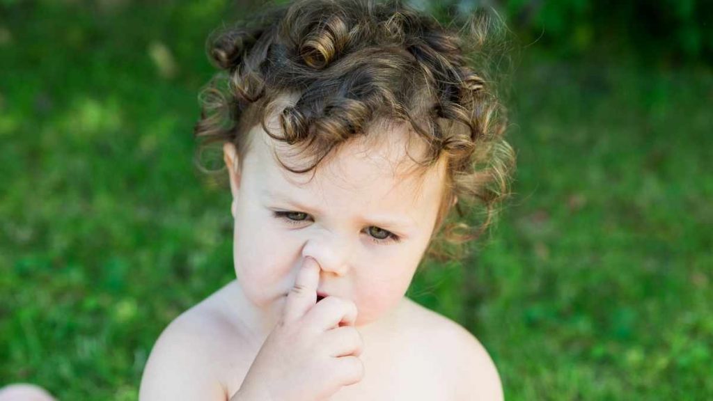 child picking nose