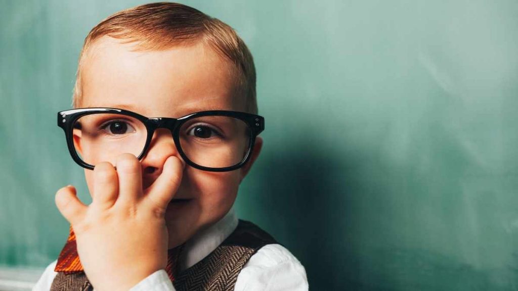 child picking nose in glasses