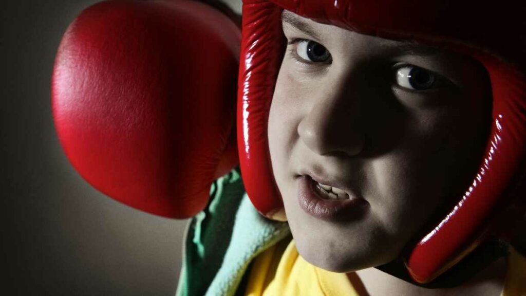 child with boxing glove punching