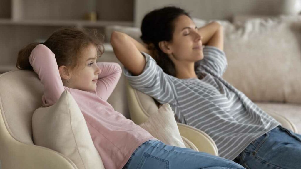 mom and daughter relaxing on sofa