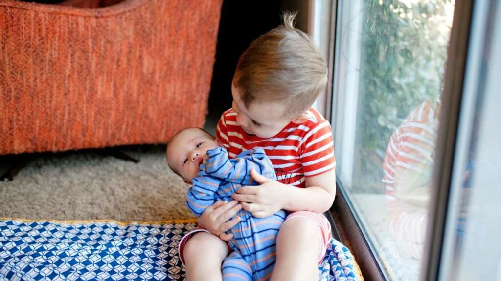 sibling helping with newborn