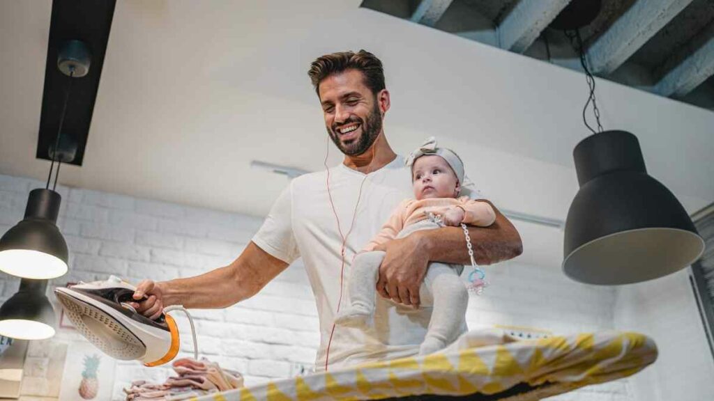 dad with baby doing chores