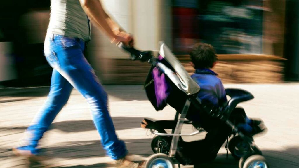 toddler in stroller walking