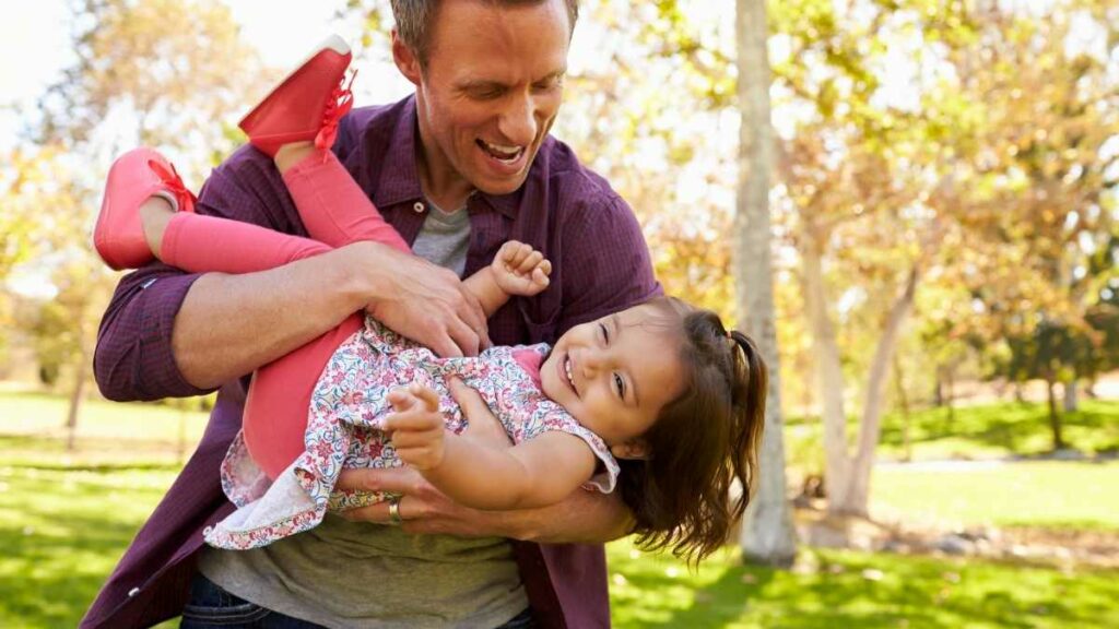 toddler playing with dad