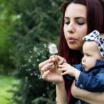 Woman-Holding-Baby-While-Blowing-Dandelion-2