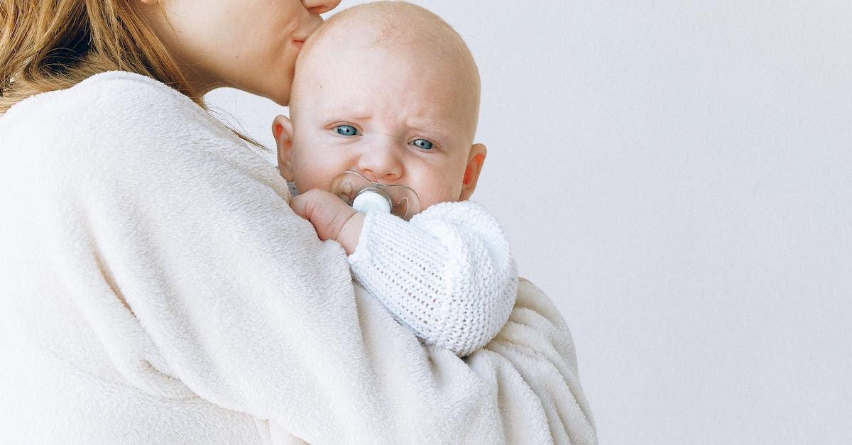 woman-carrying-girl-while-showing-smile