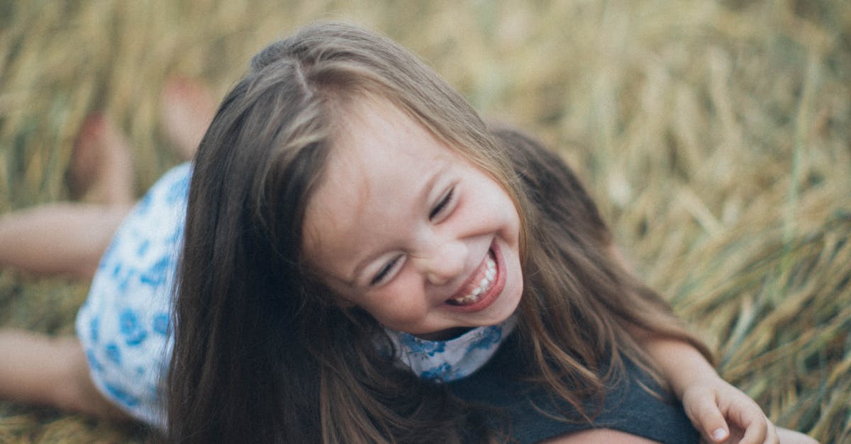 woman-carrying-girl-while-showing-smile