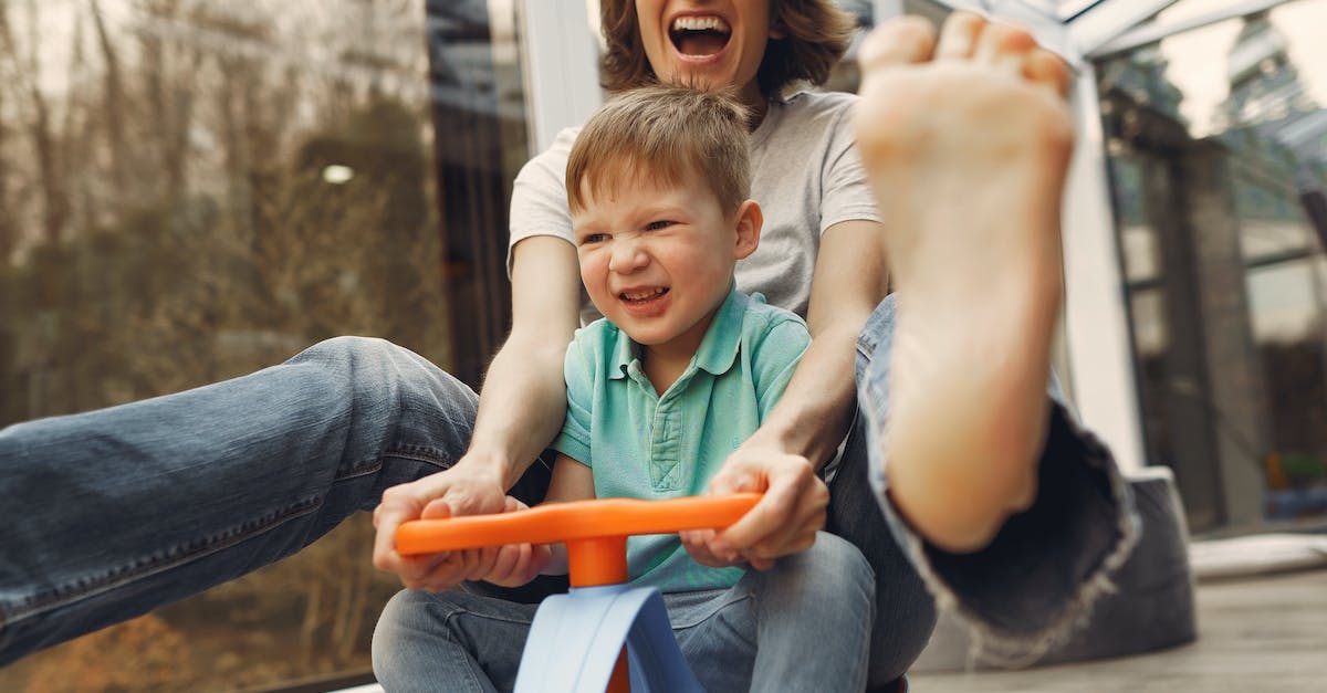 woman-carrying-girl-while-showing-smile