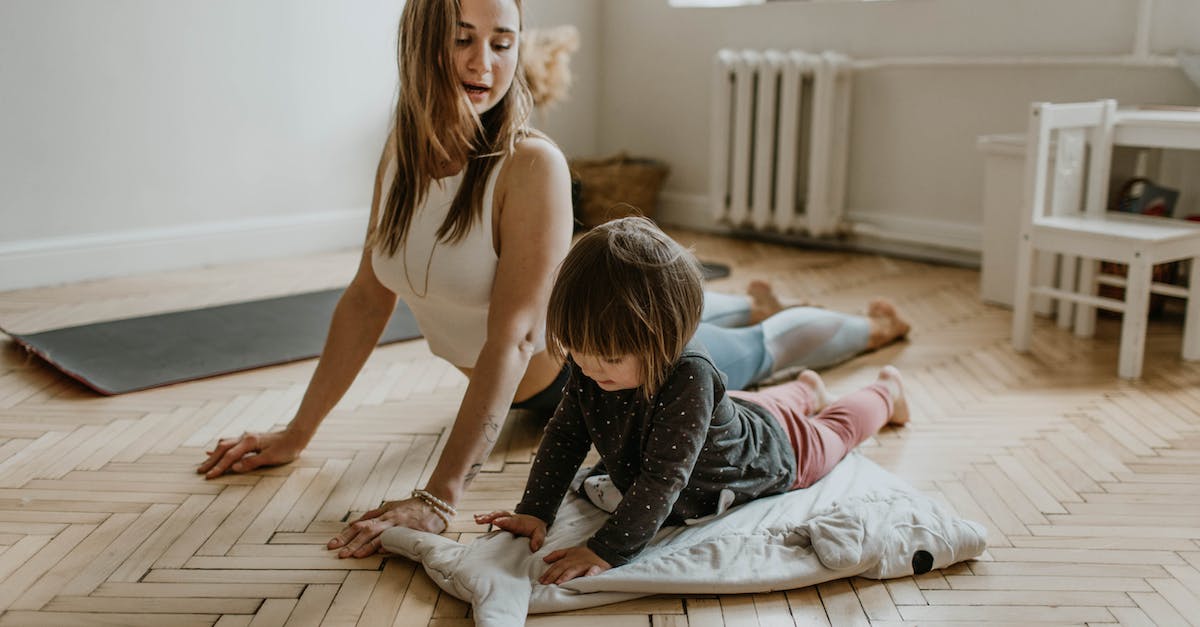 woman-carrying-girl-while-showing-smile